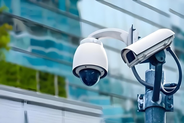 A security camera (CCTV) and an electronic access control panel